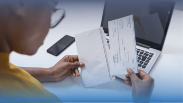 African American woman opening a check.