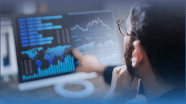 Business analyst pointing to labor market charts on his computer.