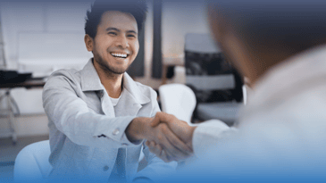 Man shaking hands with someone about a skills-based hire
