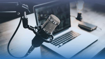 Picture of a podcast microphone and laptop