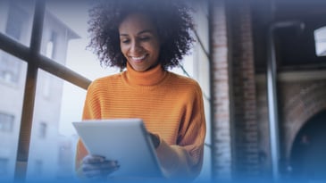 African American woman uses a tablet.