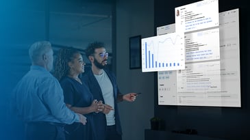 Multicultural business team look at charts from Claro Analytics.