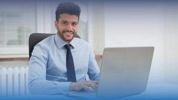 Man at computer listening to Claro speaker Mike Wolford discuss the reality of AI for talent teams and labor market intelligence