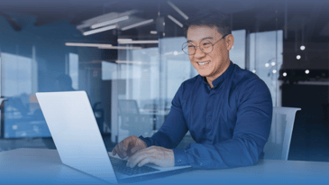 Cheerful Asian man watching a LinkedIn Live event.